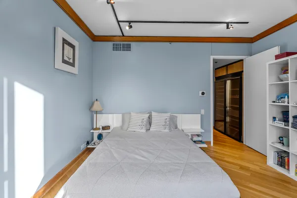 a bedroom with a bed and a book shelf