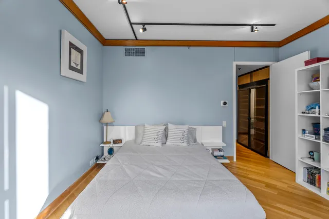 a bedroom with a bed and a book shelf