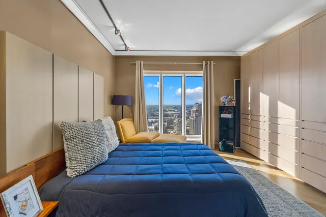 a bedroom with furniture and large windows