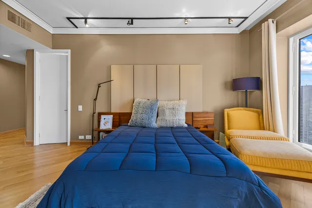 a bedroom with a bed and wooden floor