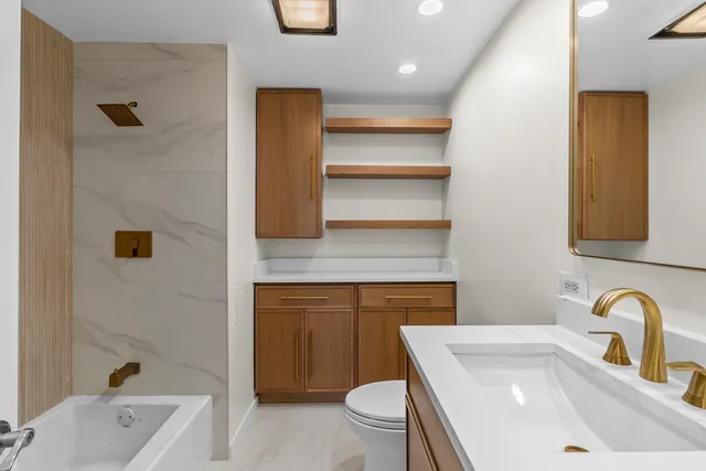 a bathroom with a sink a toilet and bathtub