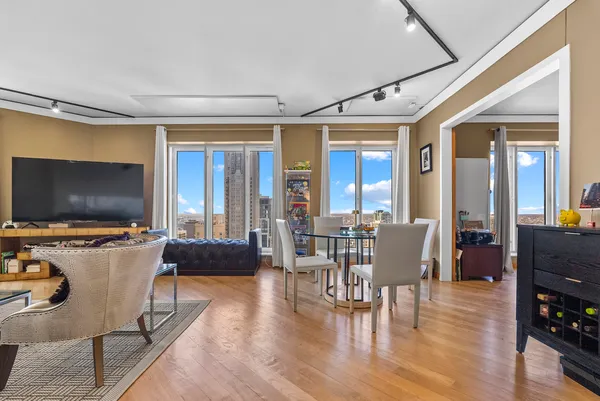 a view of a livingroom with furniture window and wooden floor