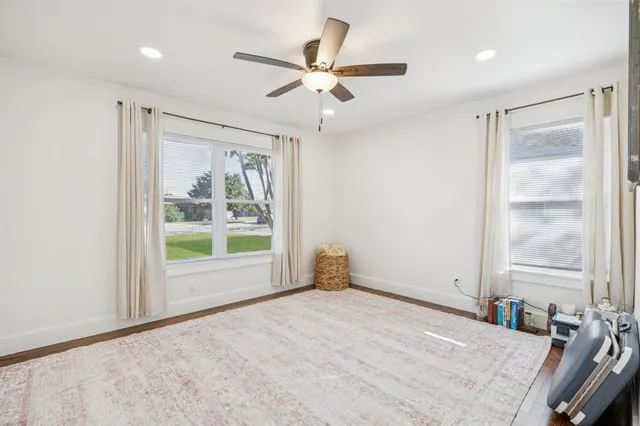 a view of a livingroom with a ceiling fan and window