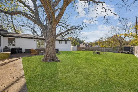 a view of a backyard with large trees