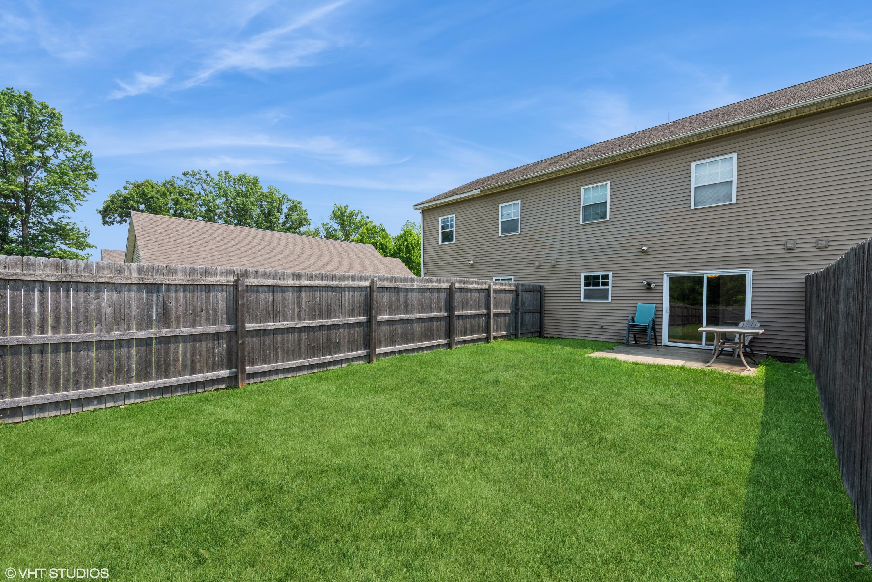 353 South Boo Road, Unit B Burns Harbor, IN 46304 - Photo 12 of 12 a view of a backyard with plants and wooden fence