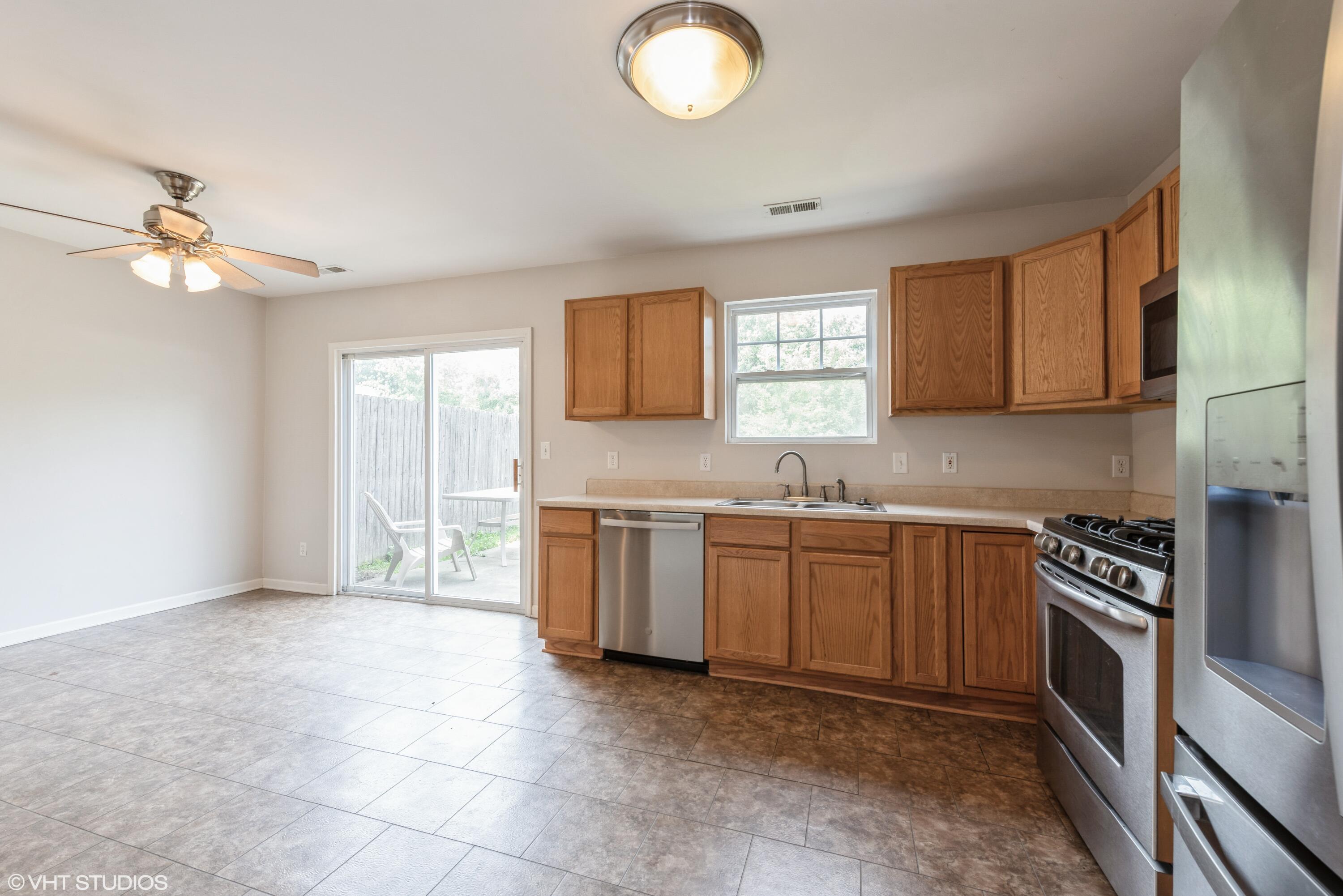 353 South Boo Road, Unit B Burns Harbor, IN 46304 - Photo 4 of 12 a kitchen with a stove a sink and a cabinet