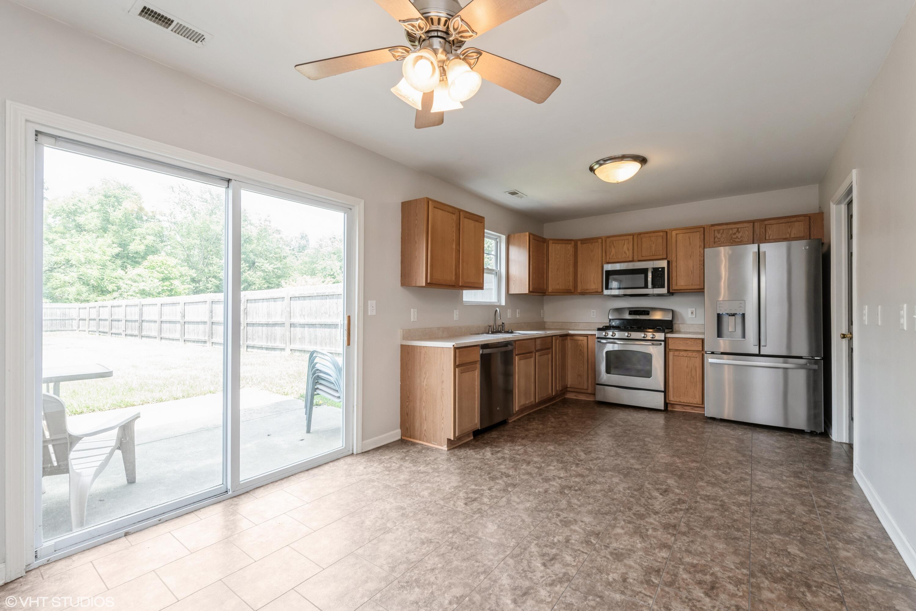 353 South Boo Road, Unit B Burns Harbor, IN 46304 - Photo 5 of 12 a kitchen with stainless steel appliances a refrigerator sink and cabinets