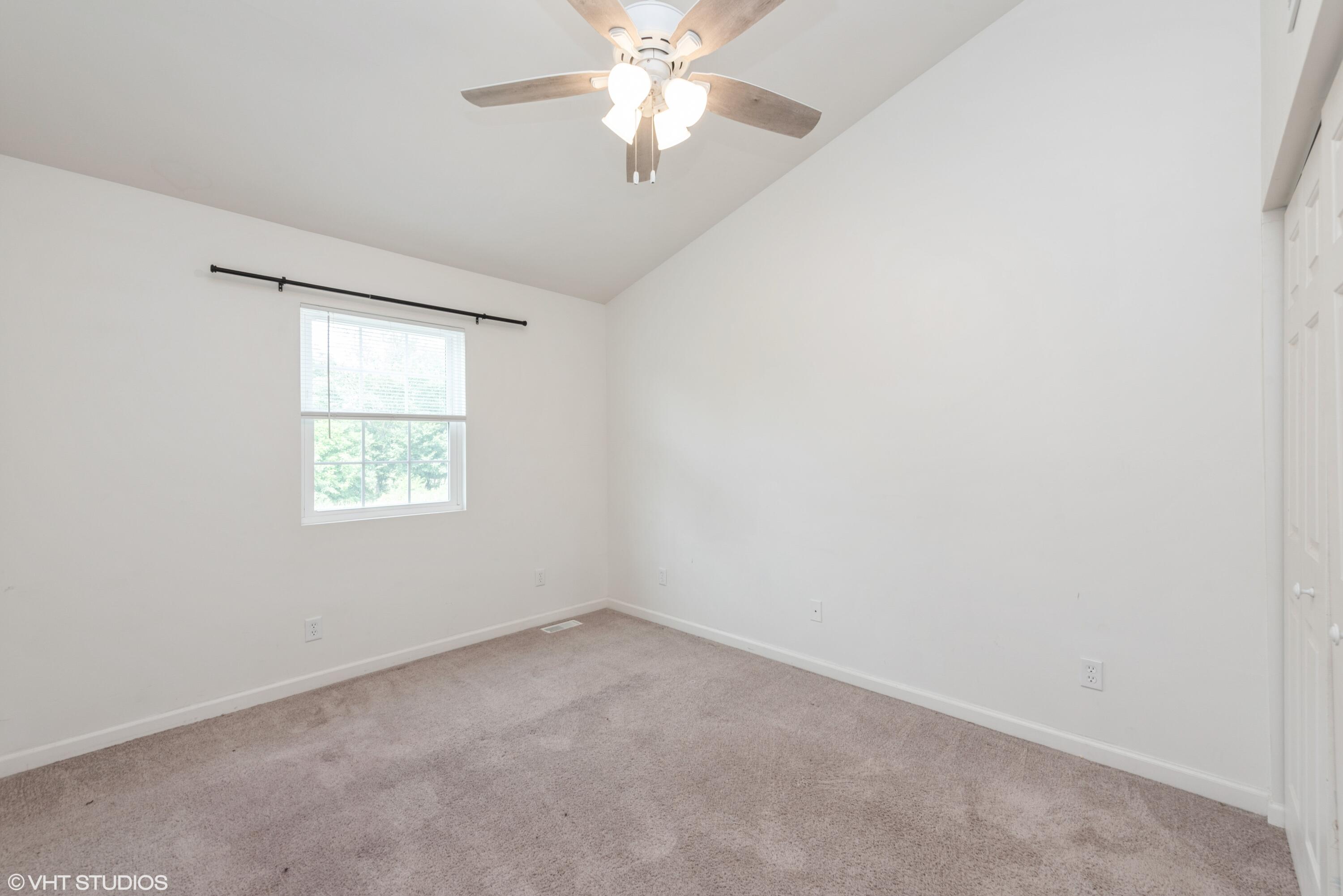353 South Boo Road, Unit B Burns Harbor, IN 46304 - Photo 8 of 12 an empty room with a window and a fan