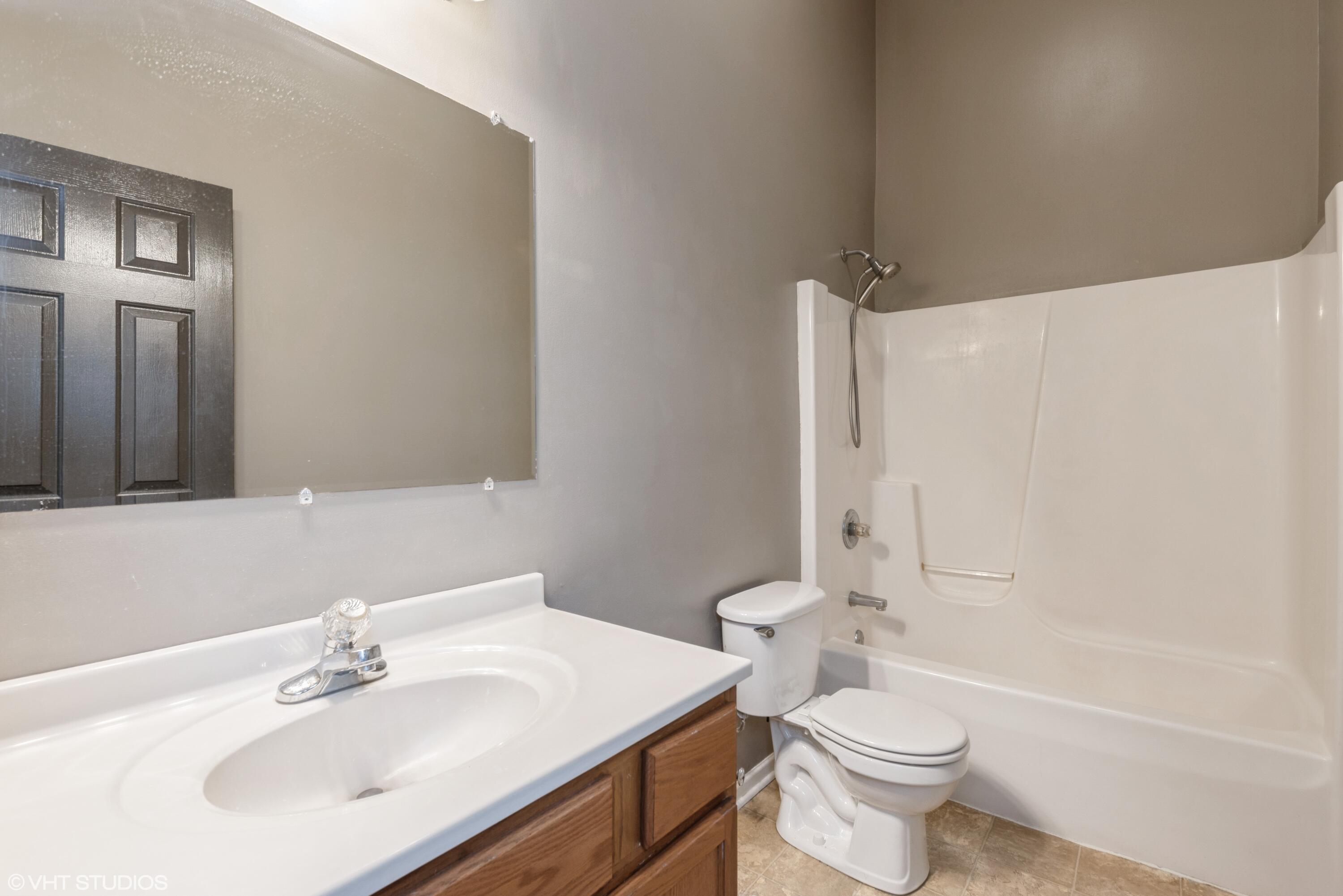 353 South Boo Road, Unit B Burns Harbor, IN 46304 - Photo 9 of 12 a bathroom with a sink toilet and shower