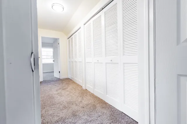 a view of empty room with white walls