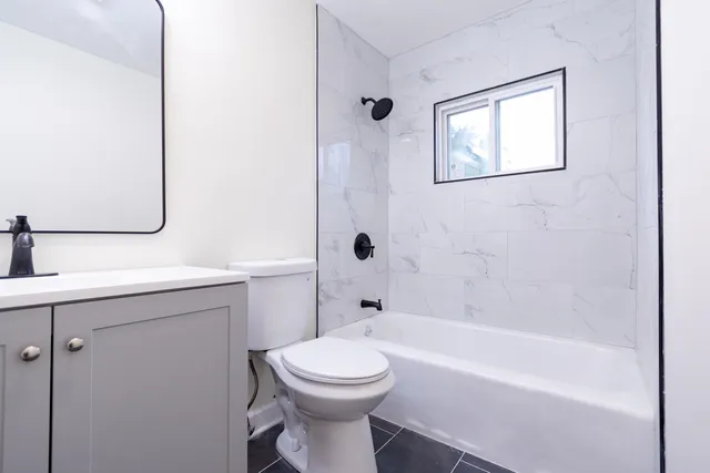 a bathroom with a toilet a sink and bathtub