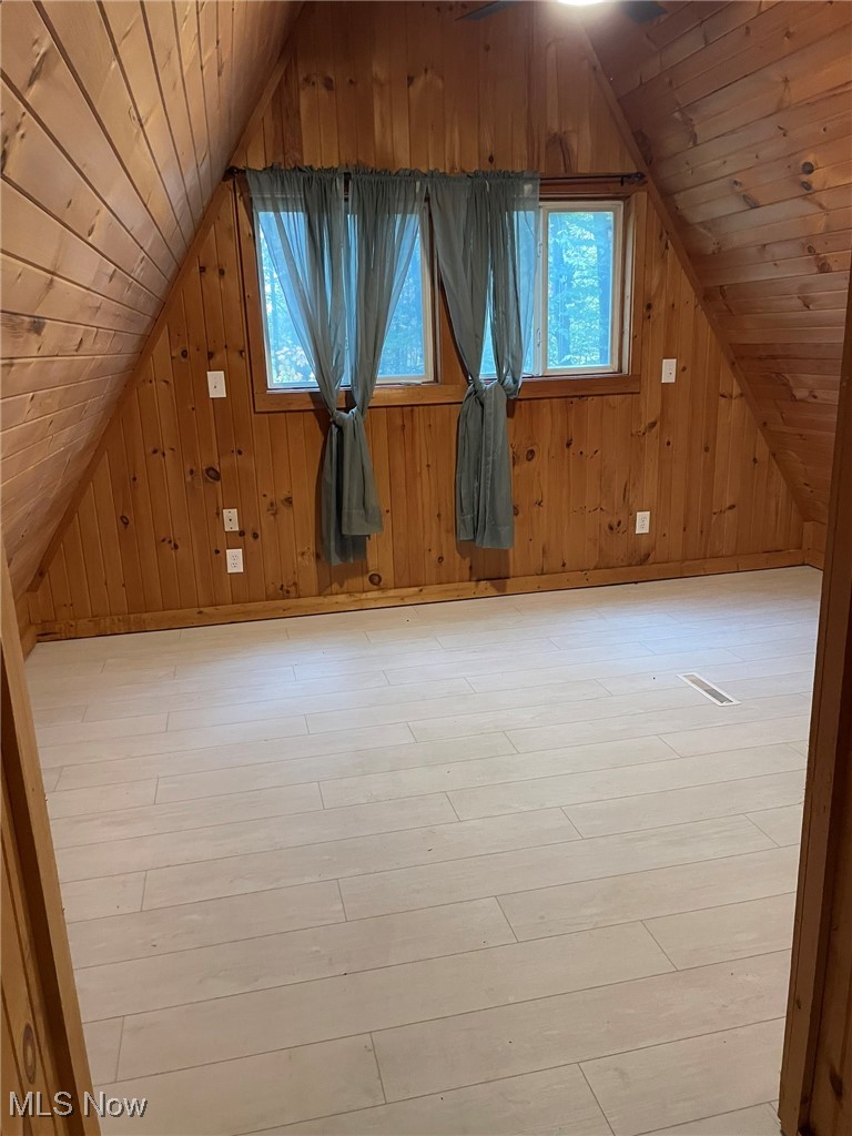 940 Long Shadow Lane Rome, OH 44085 - Photo 11 of 23 featuring wooden walls, wood ceiling, light wood-style flooring, and lofted ceiling
