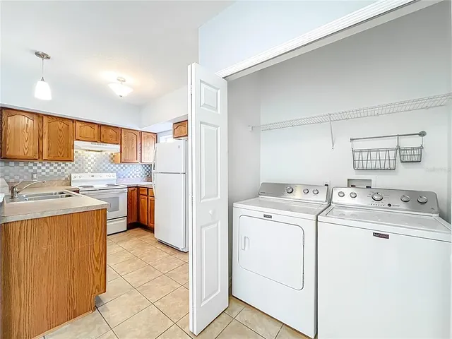 a bathroom with a granite countertop sink a mirror and shower