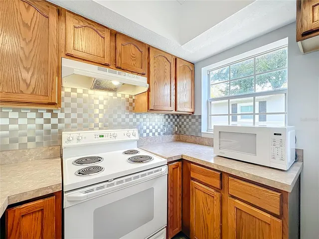 a kitchen with stainless steel appliances a stove sink and cabinets