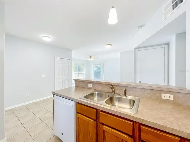 a view of a livingroom with wooden floor and a ceiling fan