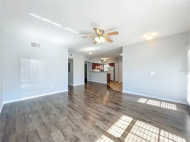 a view of a kitchen with a sink and a refrigerator