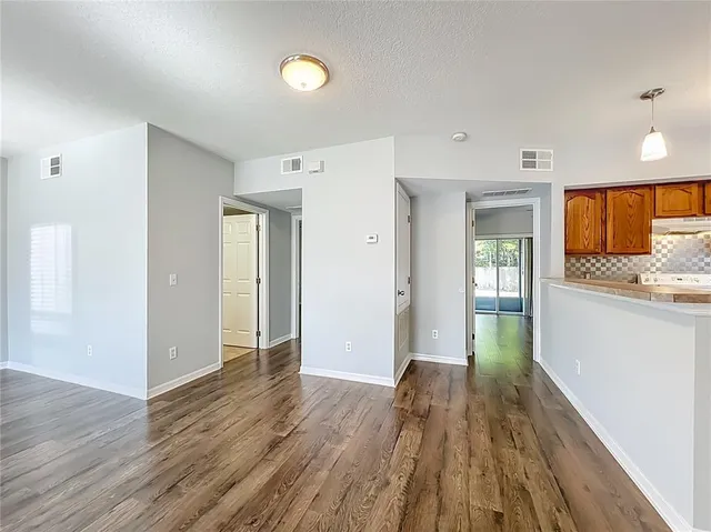 a view of a kitchen with a sink and a refrigerator