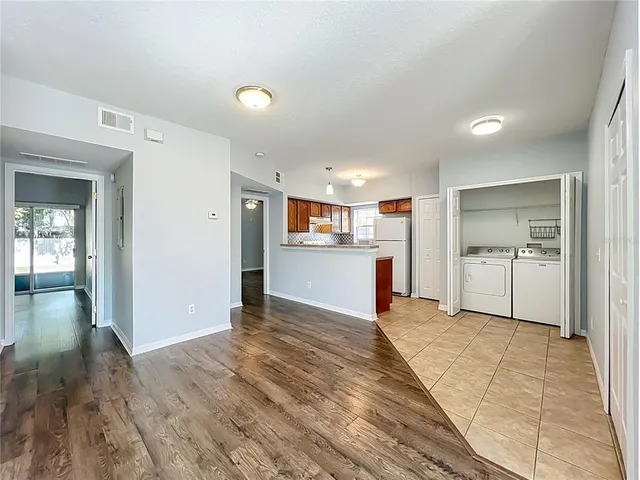 a kitchen with refrigerator and cabinets