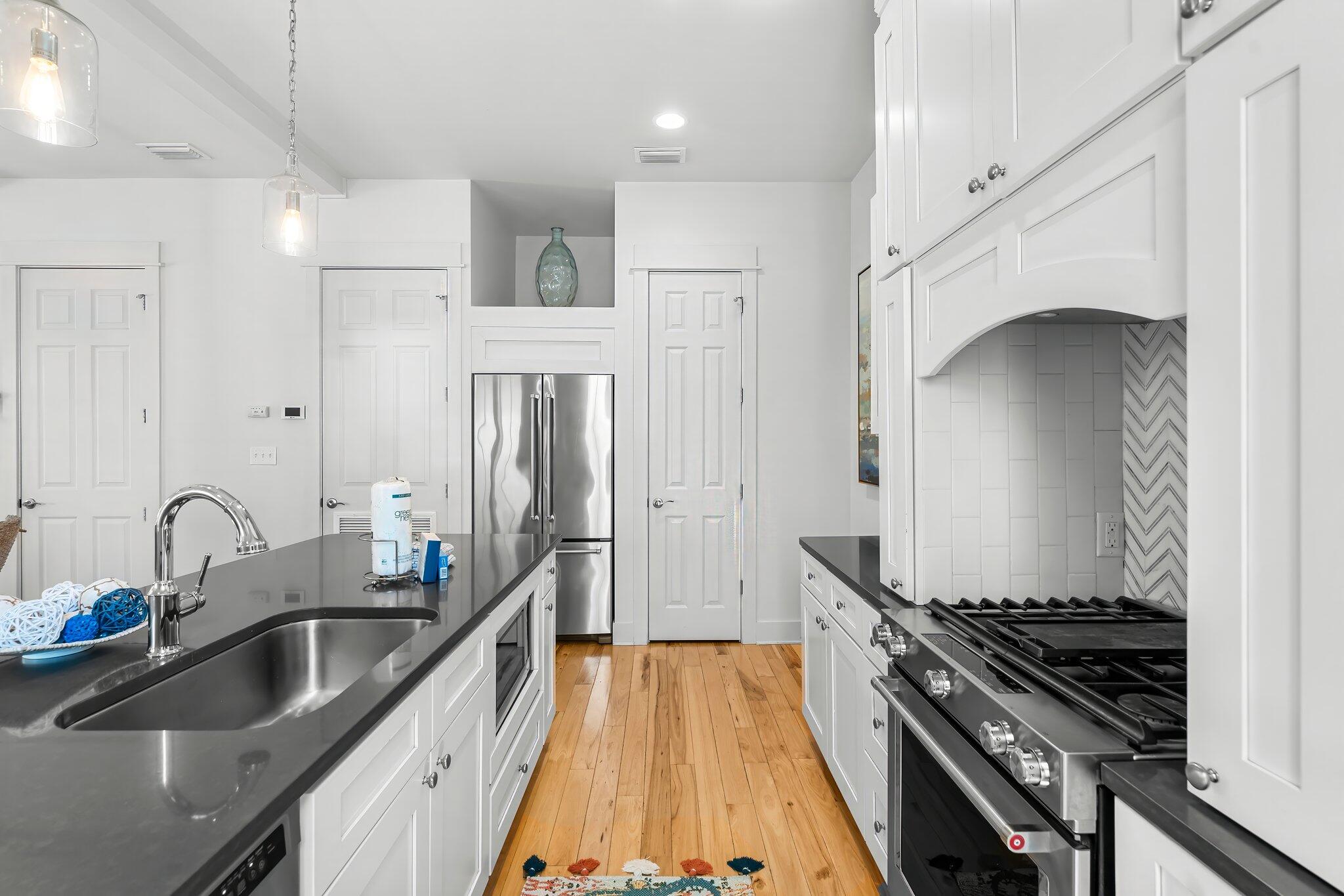 98 East Blue Crab Loop Inlet Beach, FL 32461 - Photo 16 of 74 a kitchen with stainless steel appliances a sink a stove and a refrigerator