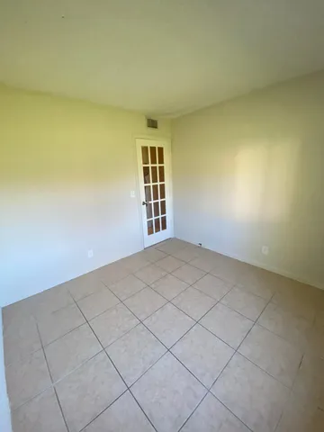 a bathroom with a glass door shower and a sink