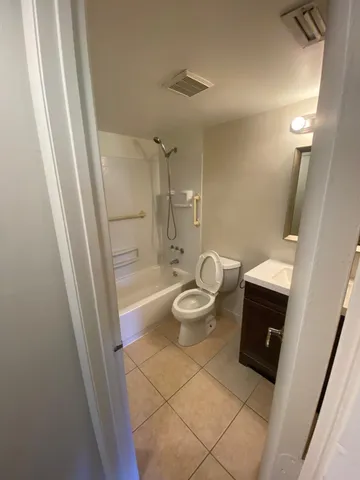 a view of a patio with a table and chairs under an umbrella