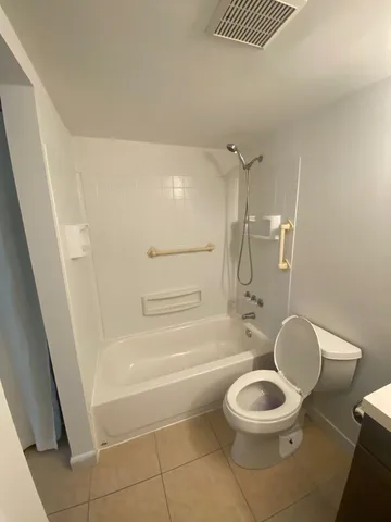 a backyard of a house with lots of green space and plants