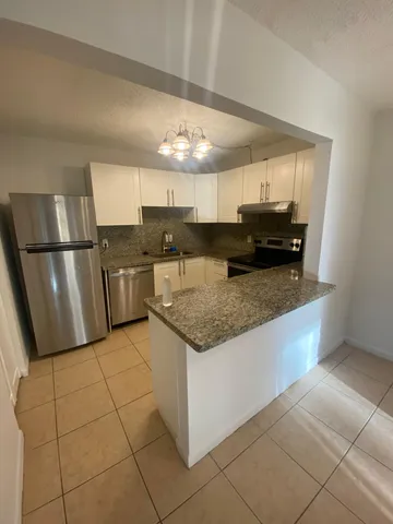 a view of a livingroom with wooden floor and a sink