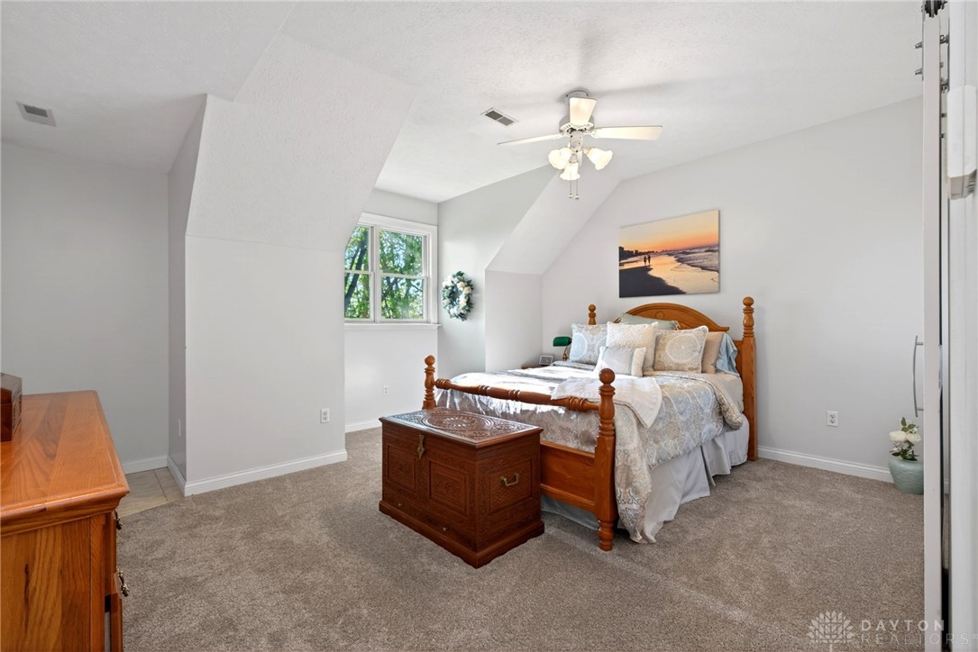 330 South Alpha Bellbrook Road Bellbrook, OH 45305 - Photo 34 of 87 This cozy bedroom features a sloped ceiling and abundant natural light, creating a comfortable retreat.