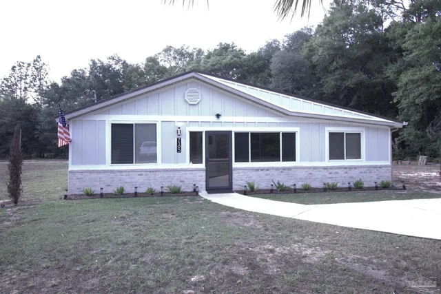 a front view of a house with a garden
