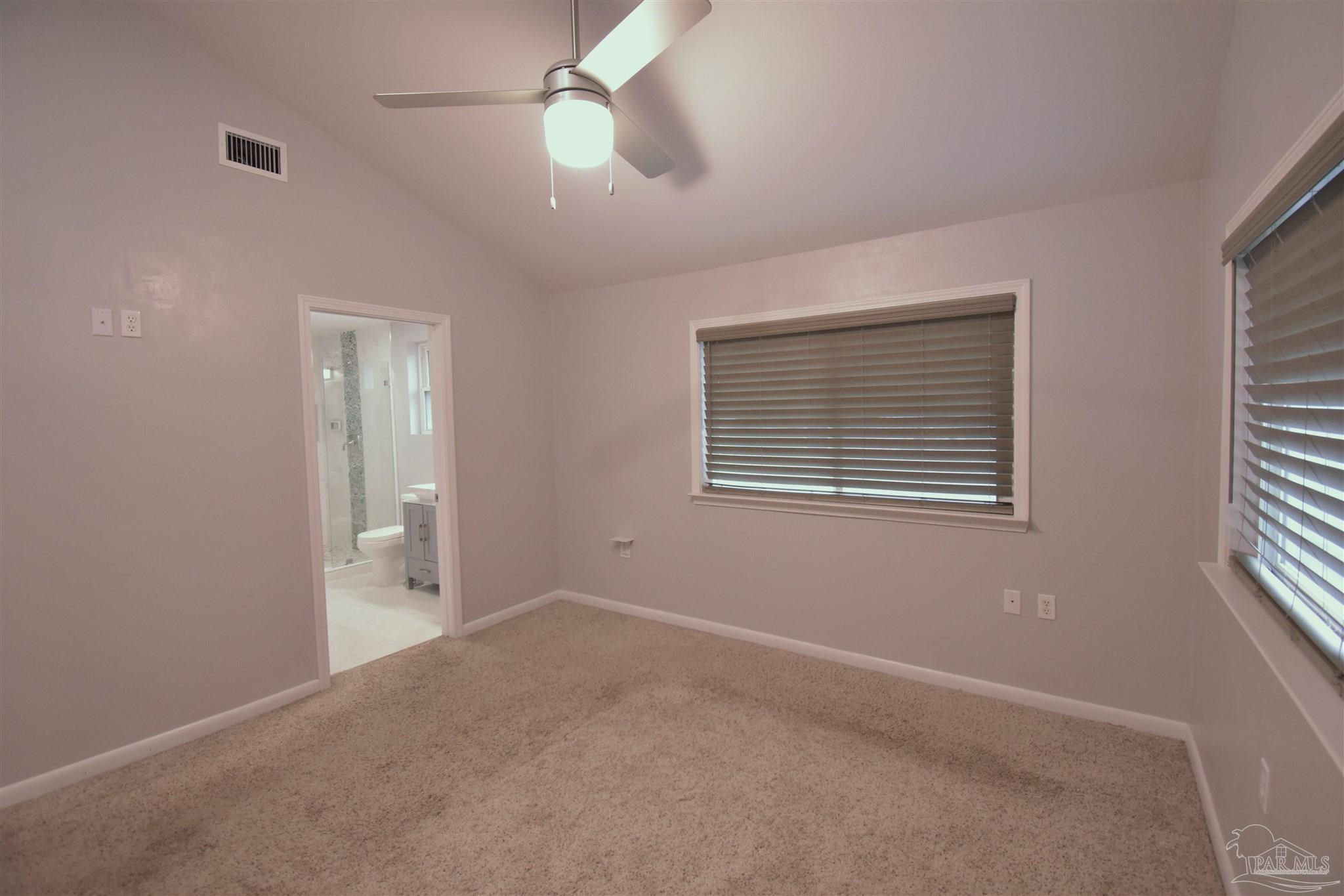 7195 Heath Road Milton, FL 32570 - Photo 13 of 33 an empty room with windows and fan