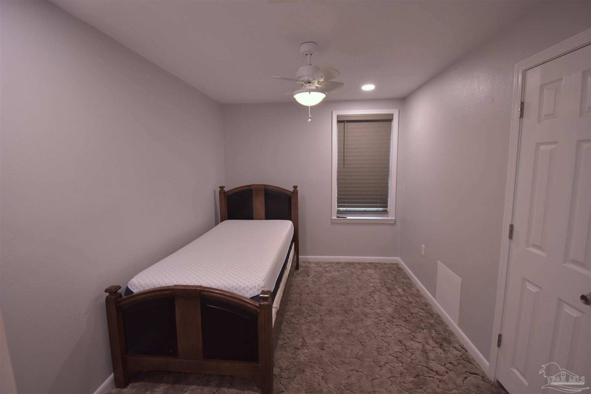 7195 Heath Road Milton, FL 32570 - Photo 18 of 33 a bedroom with a bed and a sink