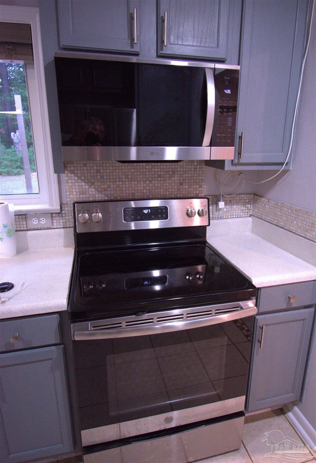 7195 Heath Road Milton, FL 32570 - Photo 24 of 33 a stove top oven sitting inside of a kitchen