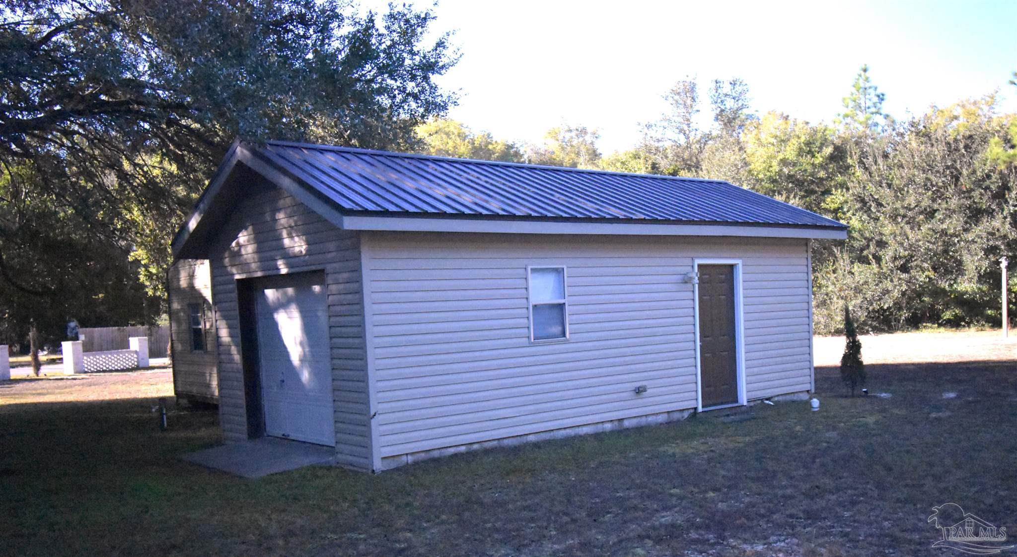 7195 Heath Road Milton, FL 32570 - Photo 30 of 33 a front view of a house with a garden