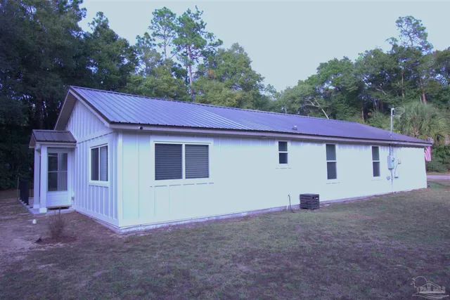 a view of a house with a backyard