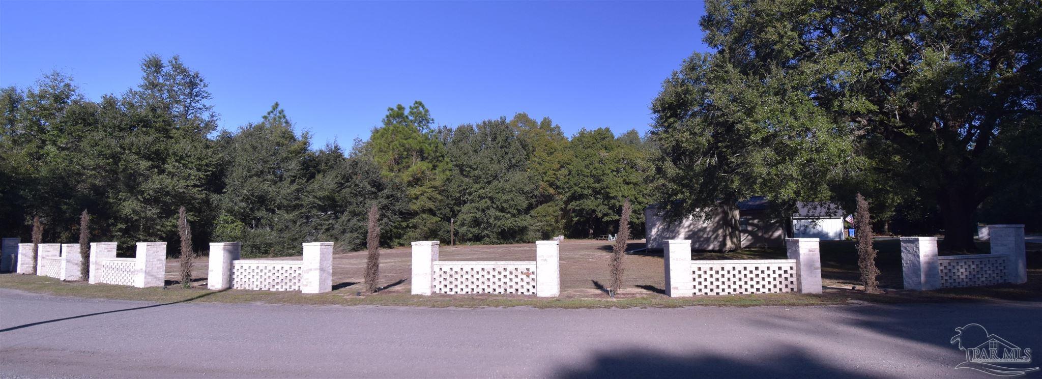 7195 Heath Road Milton, FL 32570 - Photo 33 of 33 a white house that has a tree in front of it
