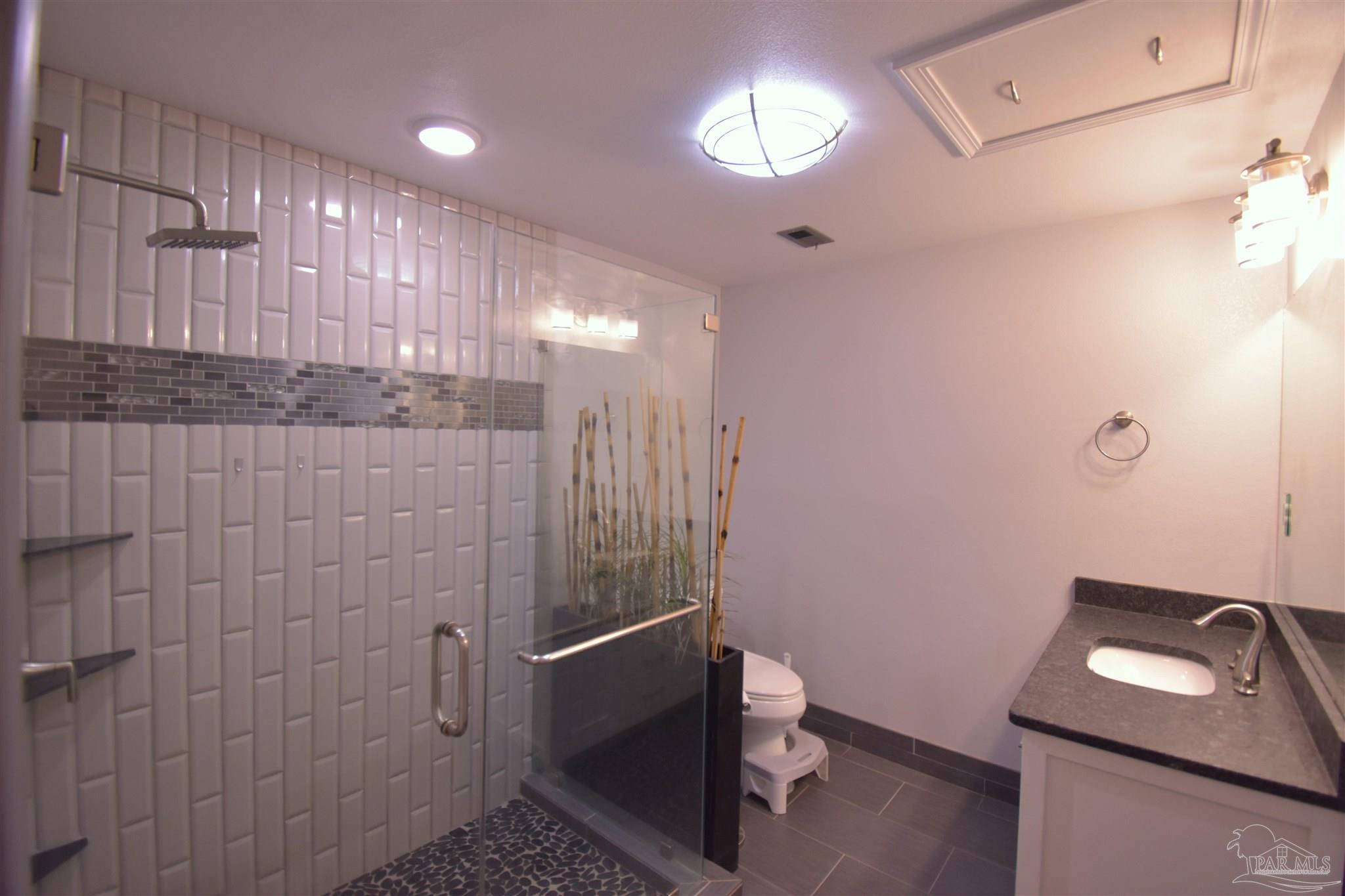 7195 Heath Road Milton, FL 32570 - Photo 9 of 33 a bathroom with a toilet a sink and mirror