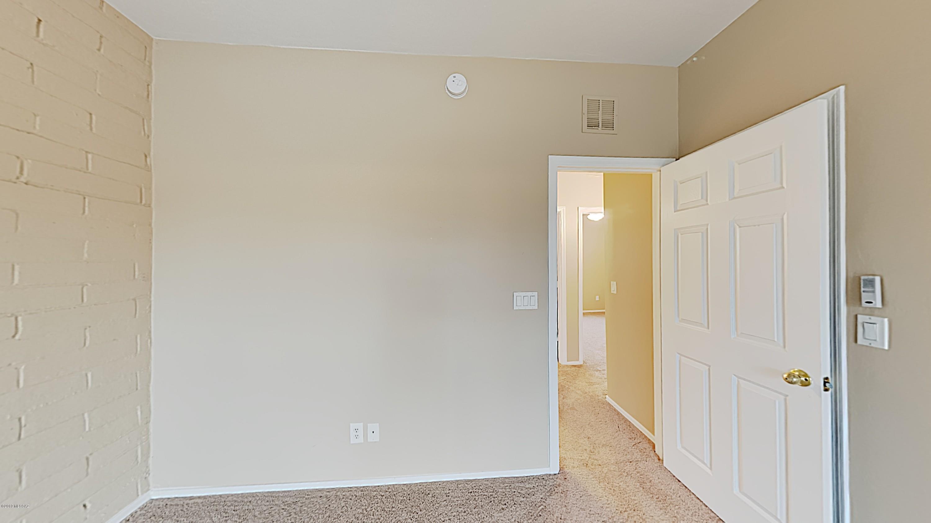 3516 South Mission Road, Unit 3 Tucson, AZ 85713 - Photo 12 of 19 a view of a hallway with wooden floor