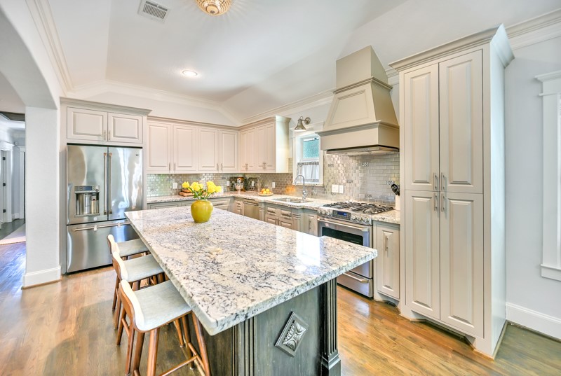 1122 East 23rd Street Houston, TX 77009 - Photo 5 of 23 Open-concept kitchen with oversized island seating, designer finishes, and seamless flow to living spaces.