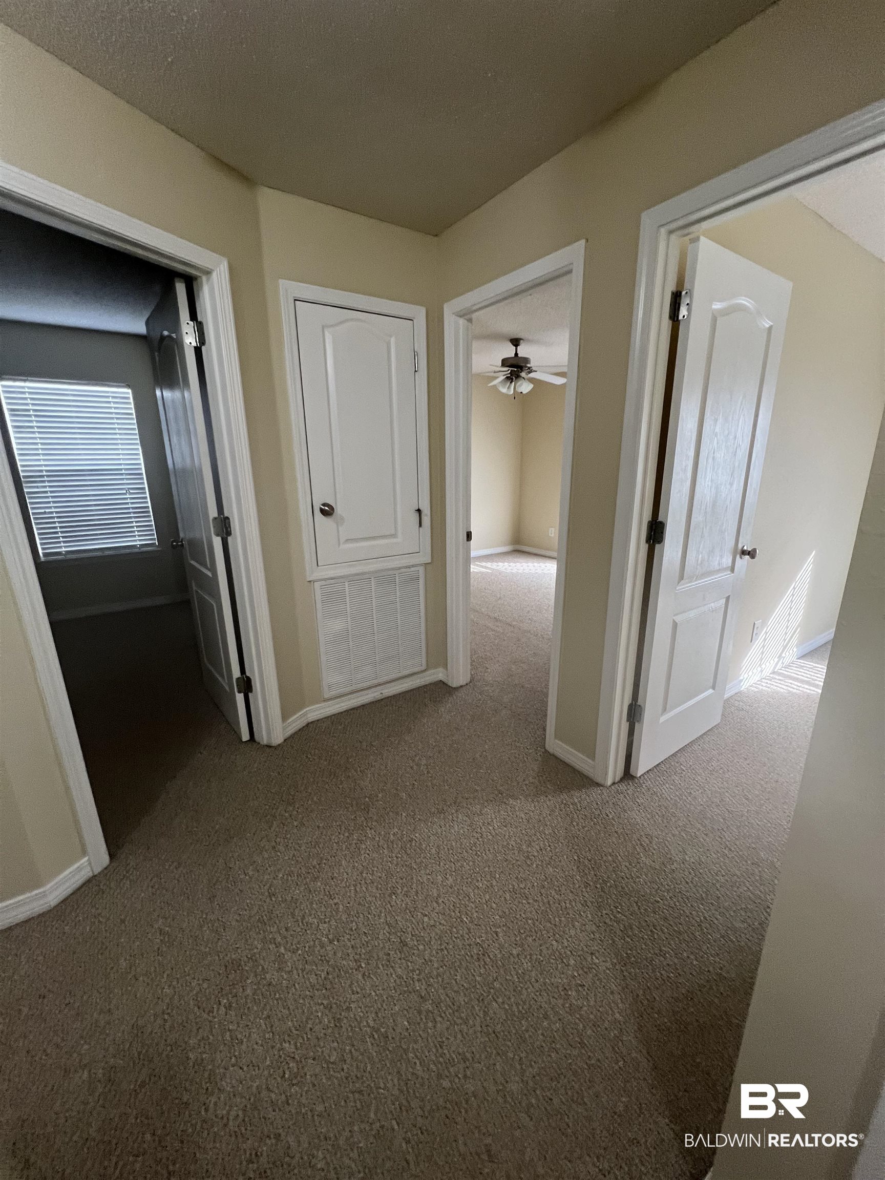 17793 Fancy Boulevard Foley, AL 36535 - Photo 12 of 34 Hallway featuring carpet floors and a textured ceiling