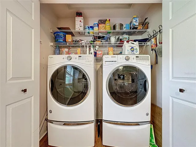 a spacious bedroom with a bed a chandelier a dresser and a chandelier