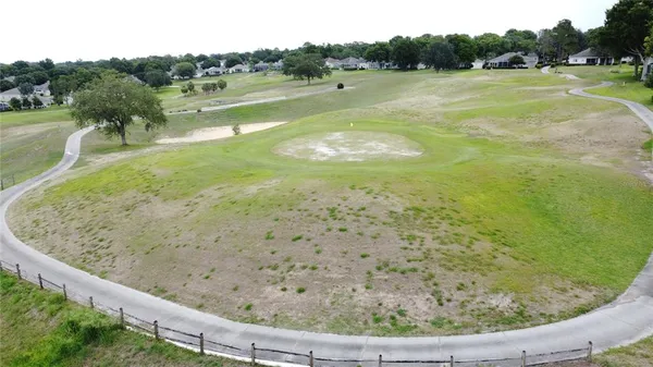 a kitchen with a table chairs refrigerator and cabinets