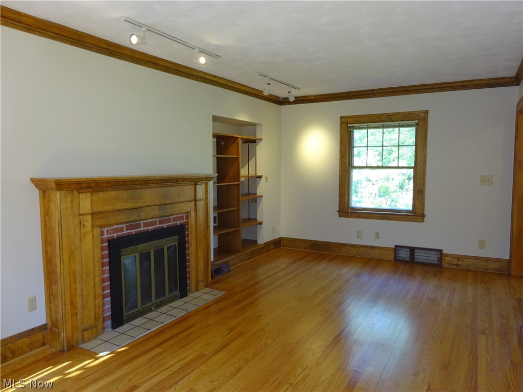 971 Roanoke Road Cleveland, OH 44121 - Photo 3 of 19 Pretty wood mantelpiece complements the hardwood floors.