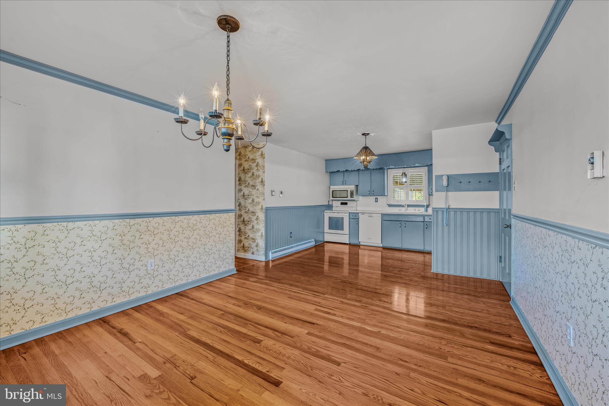 5694 Tabler Station Road Inwood, WV 25428 - Photo 13 of 37 a view of a room with wooden floor and a kitchen