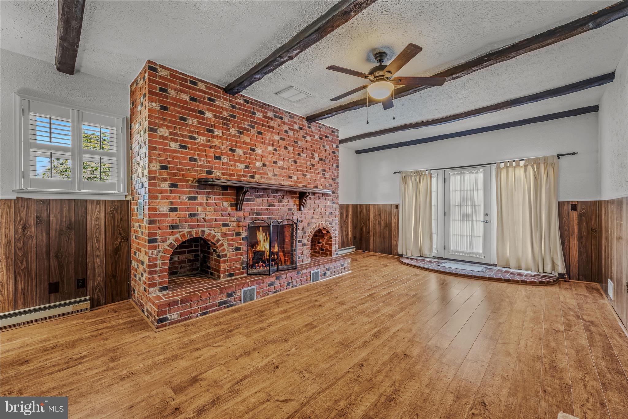 5694 Tabler Station Road Inwood, WV 25428 - Photo 18 of 37 a view of a livingroom with wooden floor and a fireplace