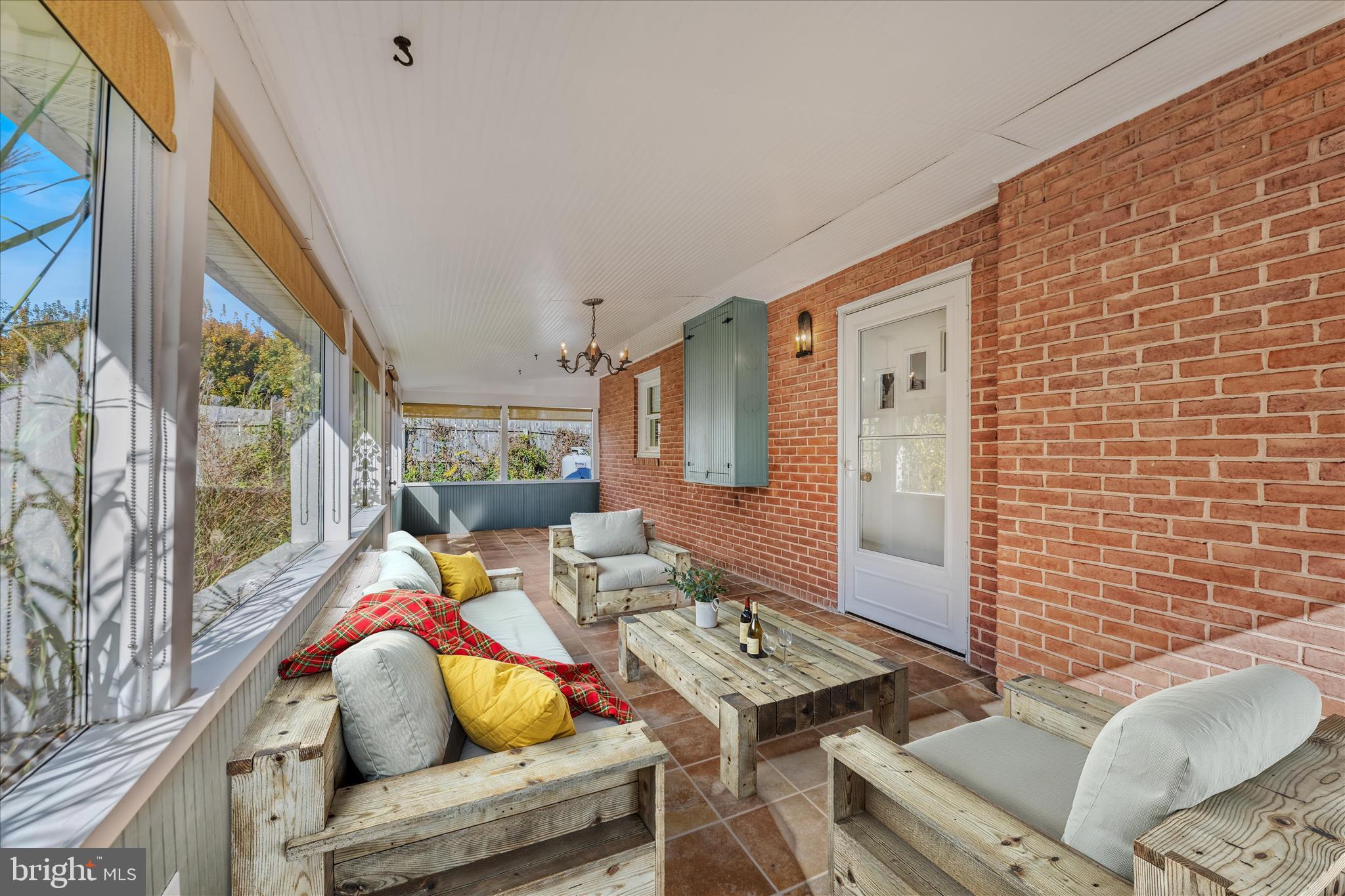 5694 Tabler Station Road Inwood, WV 25428 - Photo 29 of 37 a living room with furniture and a floor to ceiling window