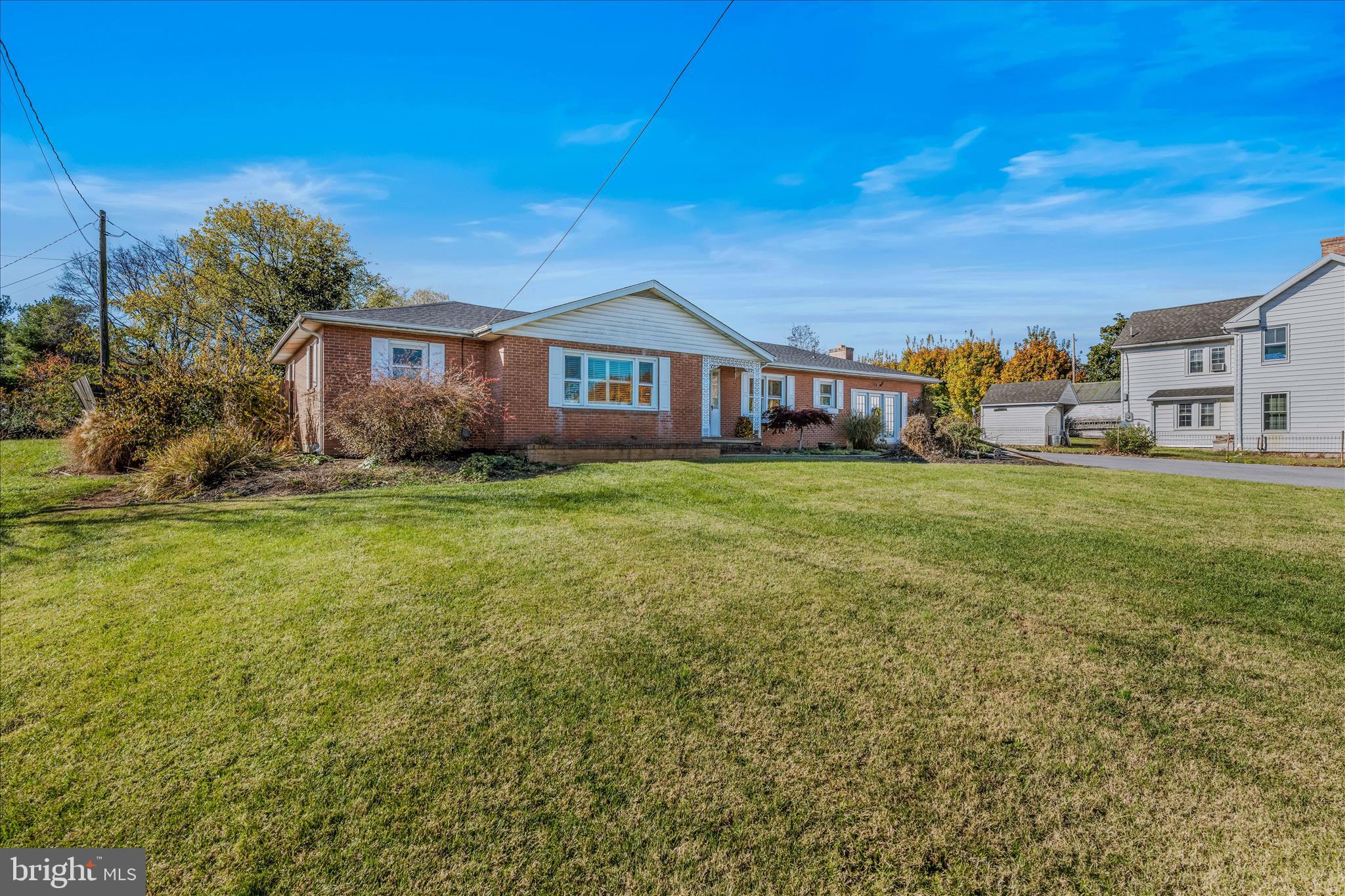 5694 Tabler Station Road Inwood, WV 25428 - Photo 3 of 37 a view of a house with a big yard and large trees
