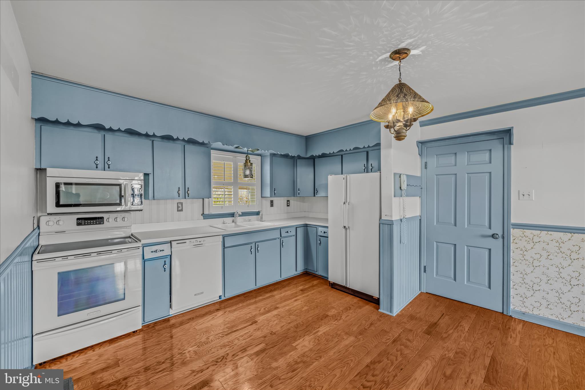 5694 Tabler Station Road Inwood, WV 25428 - Photo 6 of 37 a kitchen with white cabinets and stainless steel appliances