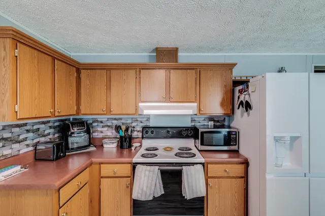 a kitchen with a stove a refrigerator and a sink