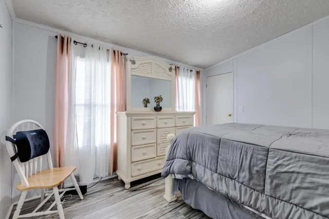 a bedroom with a bed and a chair