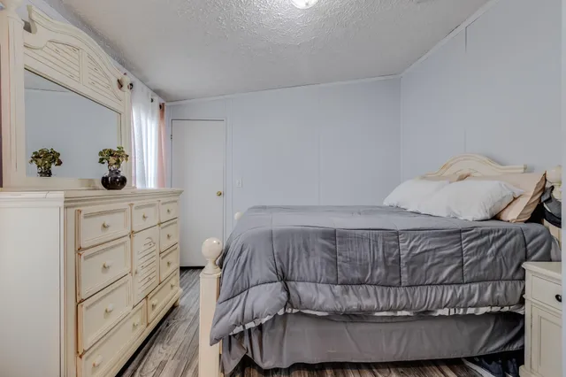 a bedroom with a bed and a dresser